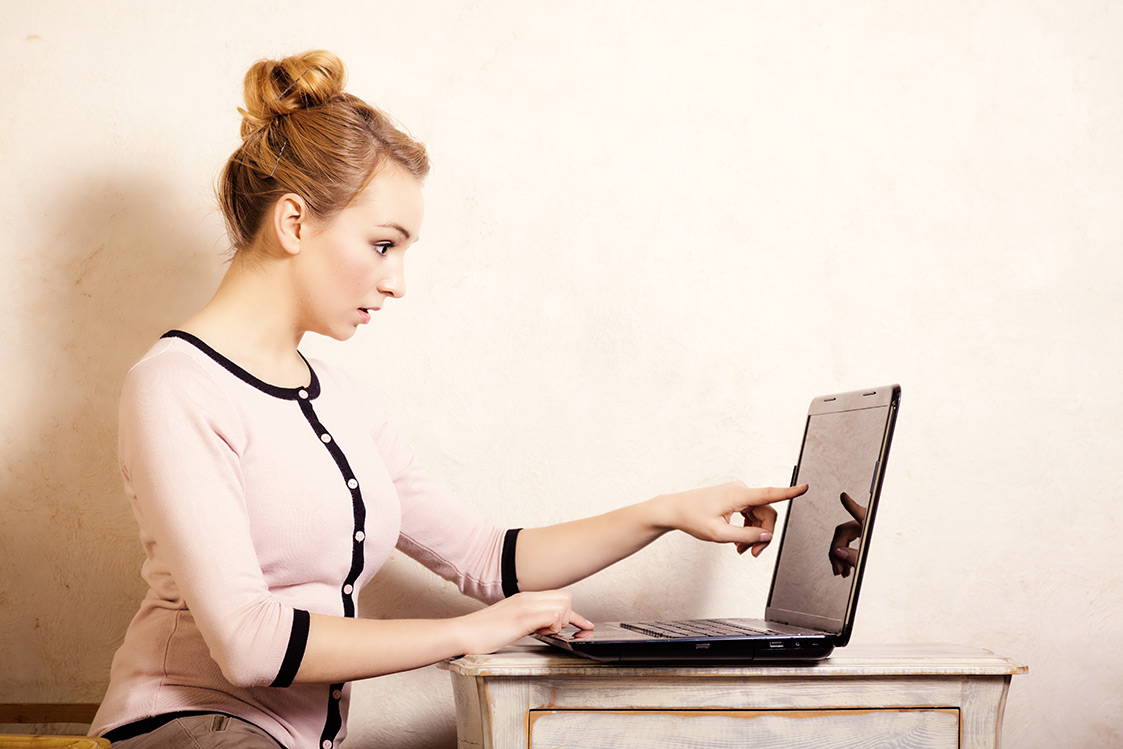 Woman blogging on computer / laptop